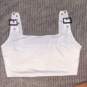white crop top with buckle straps. NEVER WORN.